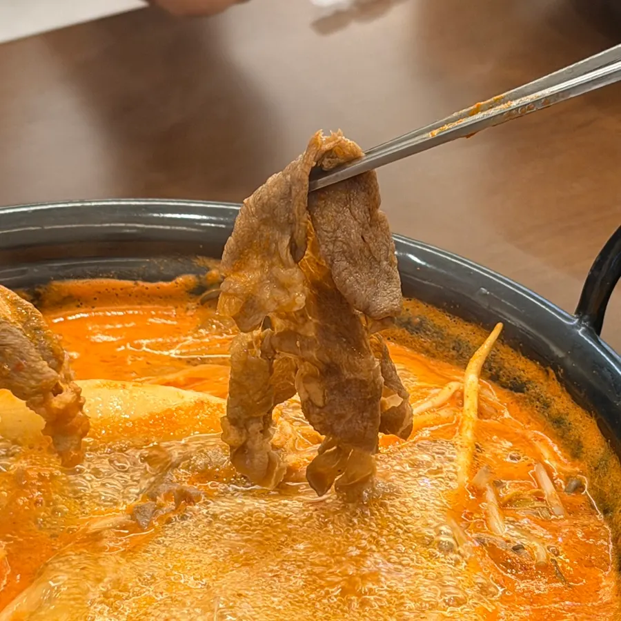 Shabu beef cooked and lifted out of the broth