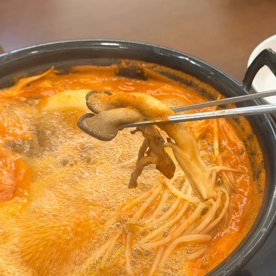 Lifting out mushroom soaked in the broth