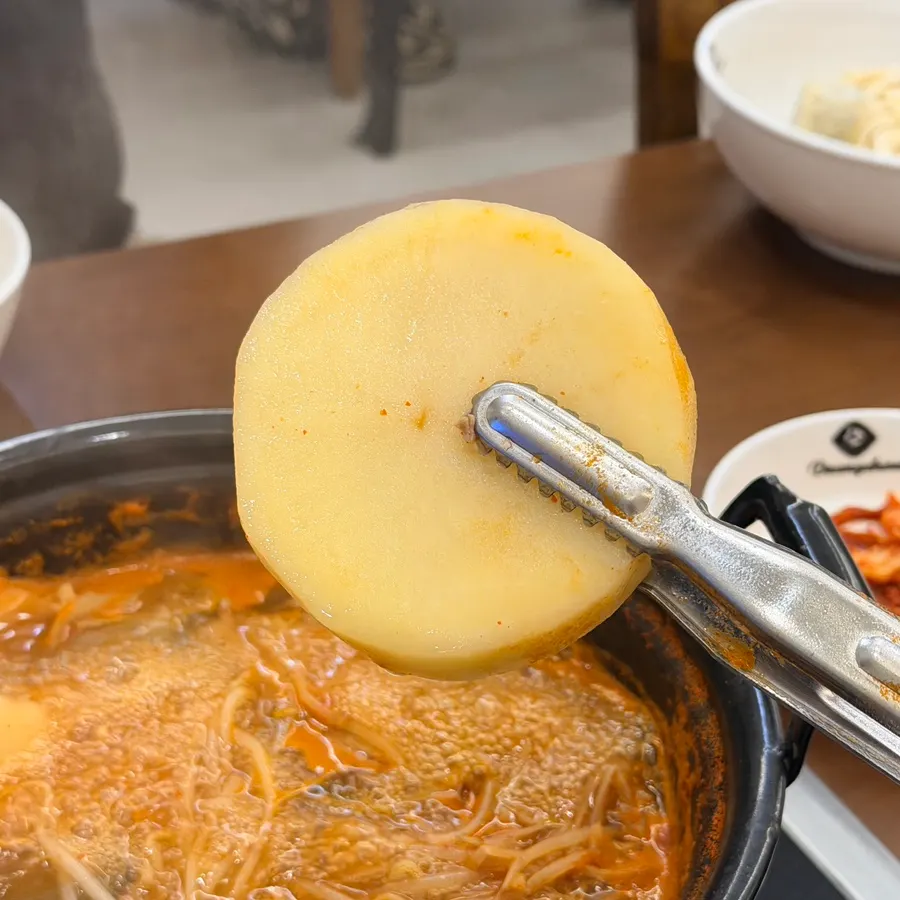 Thick-cut potato added to the pot
