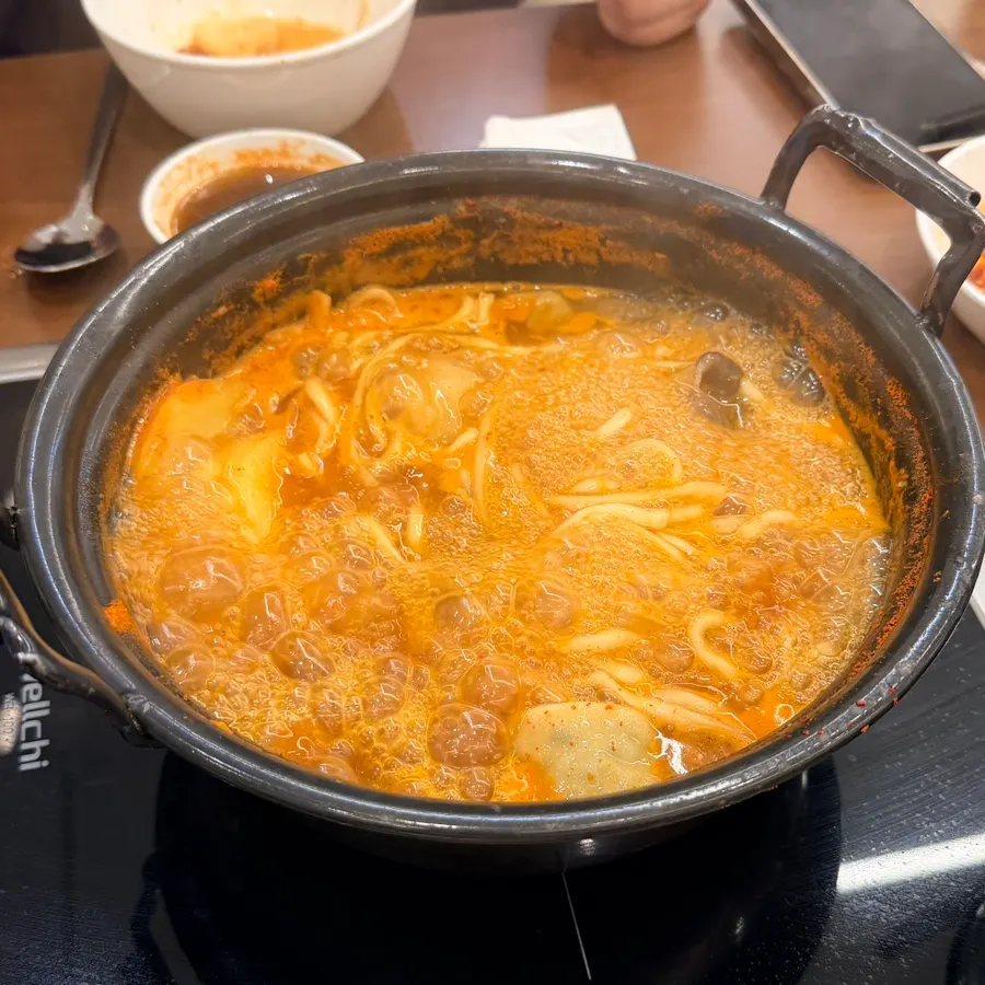 Kalguksu noodles and dumplings added to the richer broth