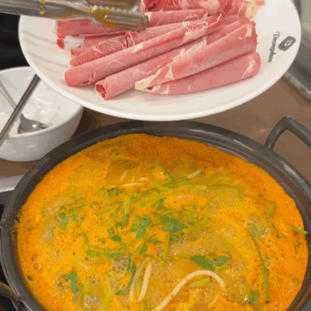 Spicy mushroom shabu-shabu broth coming to a boil