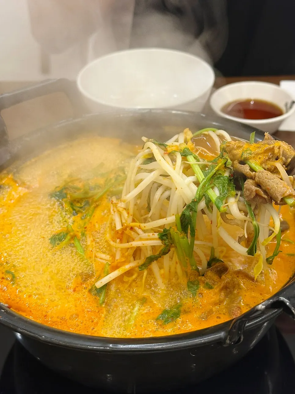 Dipping shabu-shabu meat into the broth