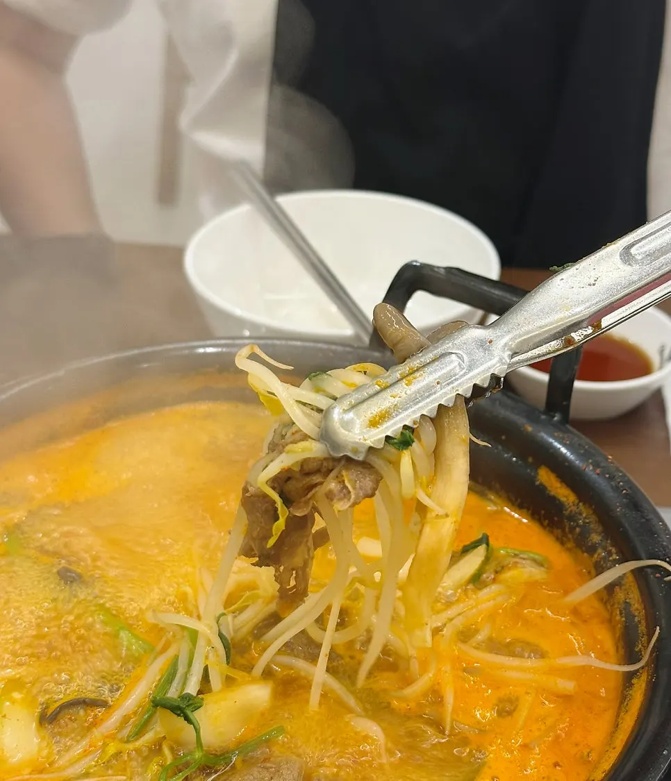 A plate of cooked vegetables and meat set aside