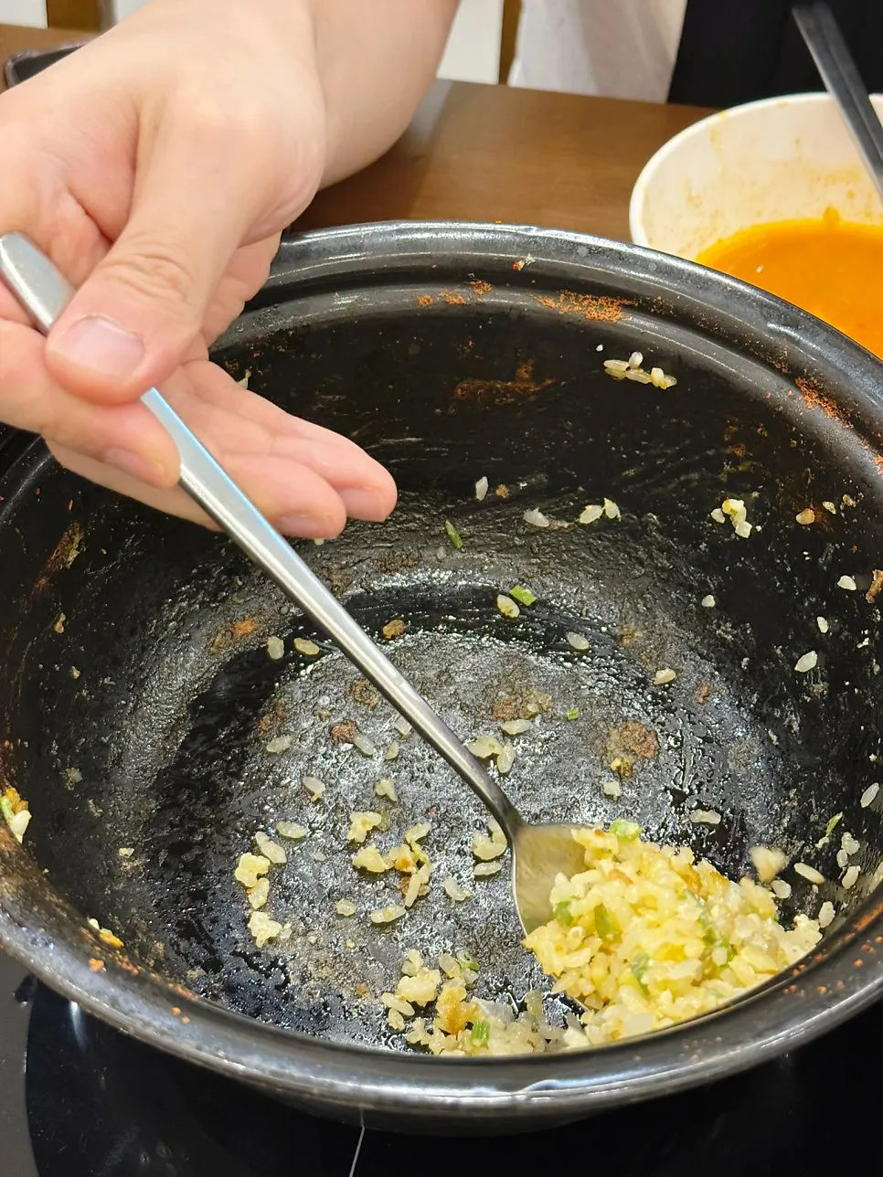 A spoonful of fried rice with egg