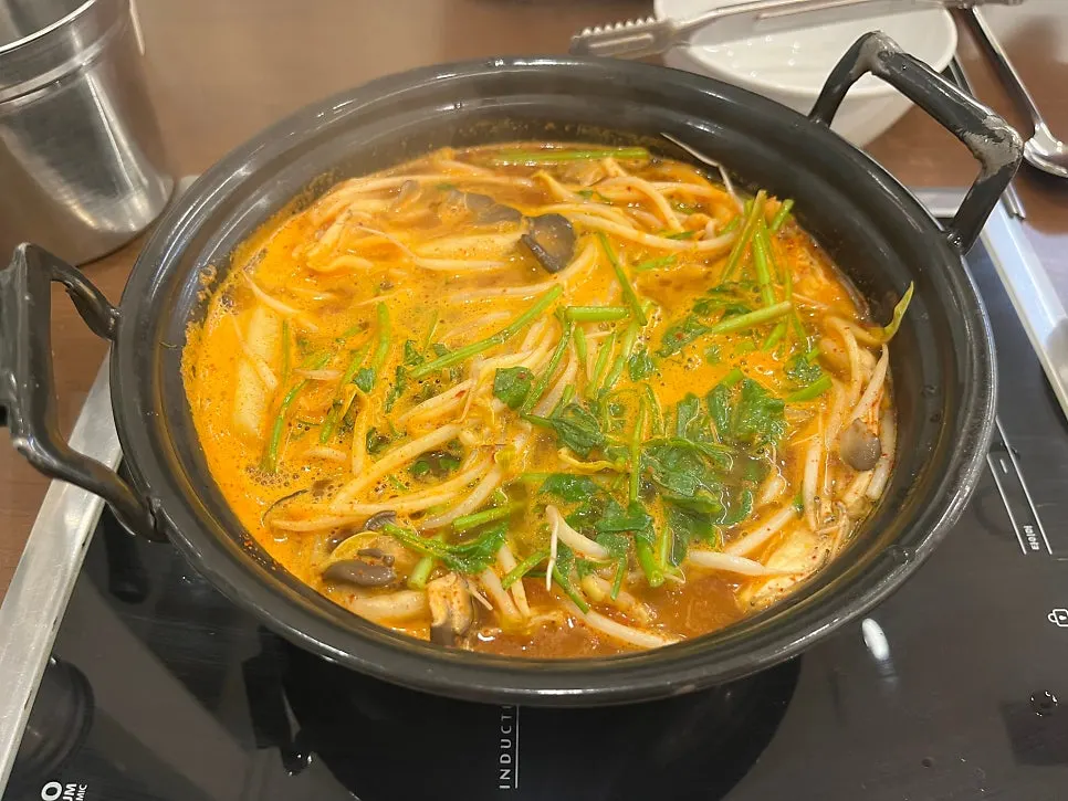 Vegetables added to the boiling spicy broth
