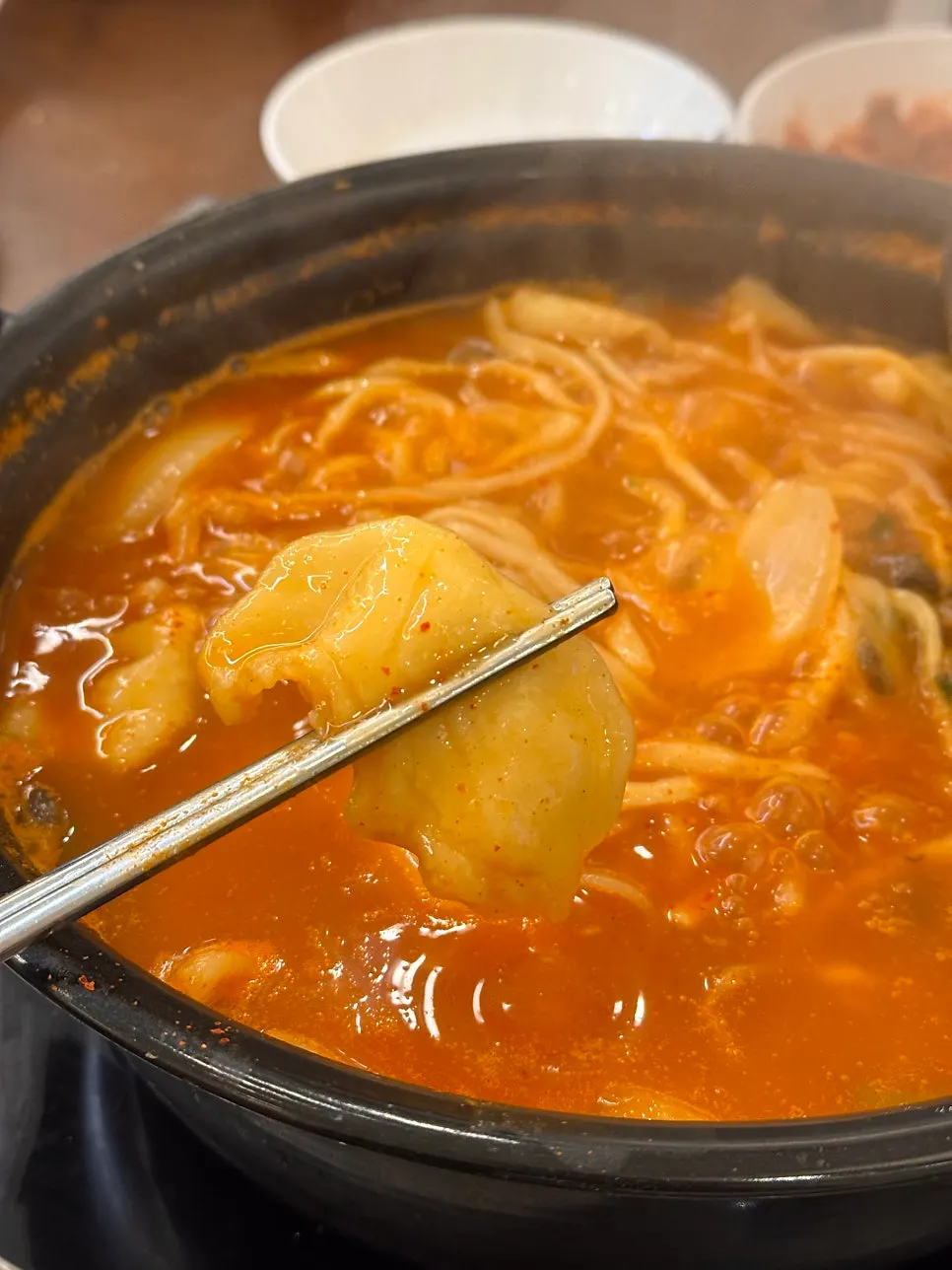 Sujebi cooking in the boiling spicy broth
