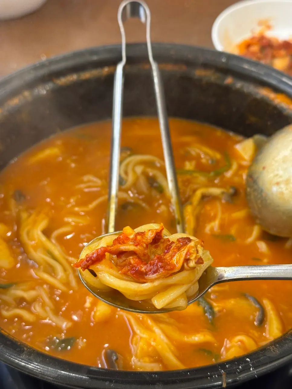 Small plate of kalguksu noodles served with kimchi