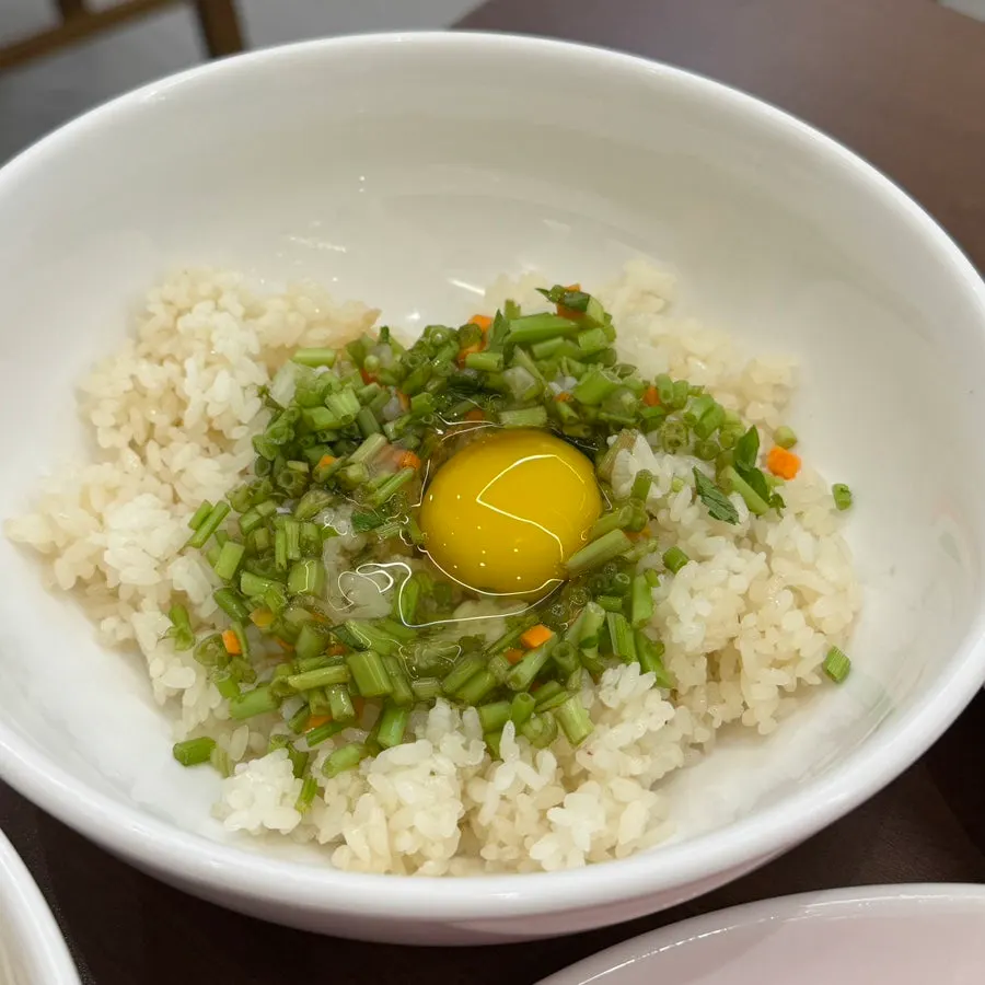 Bowl of rice and side dishes for the fried rice finish