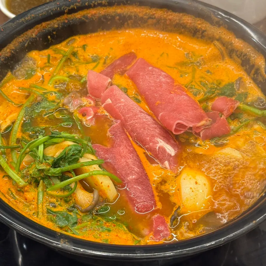 Beef and mushrooms simmering in the shabu-shabu pot