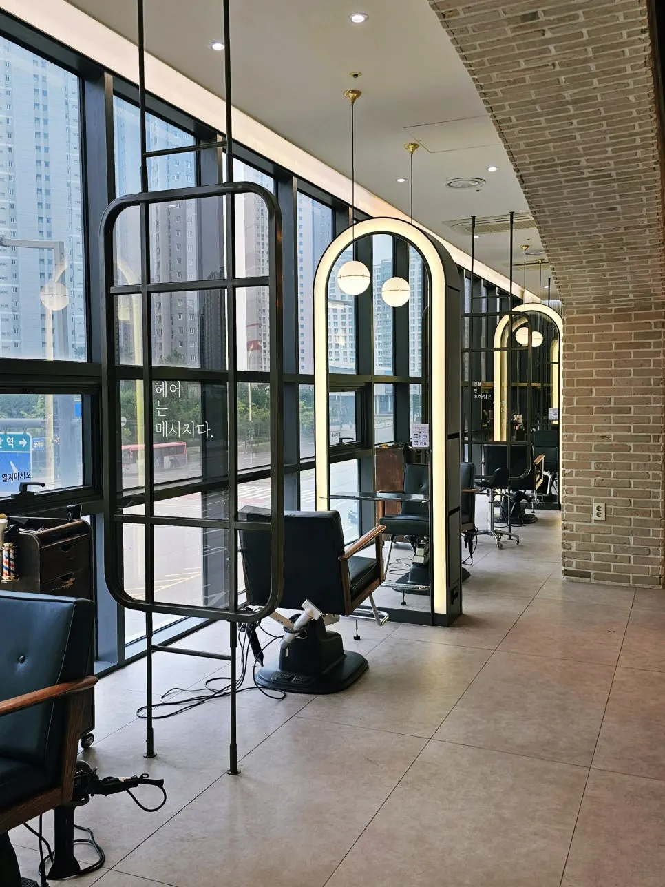 Styling chairs spaced out beside a floor-to-ceiling window
