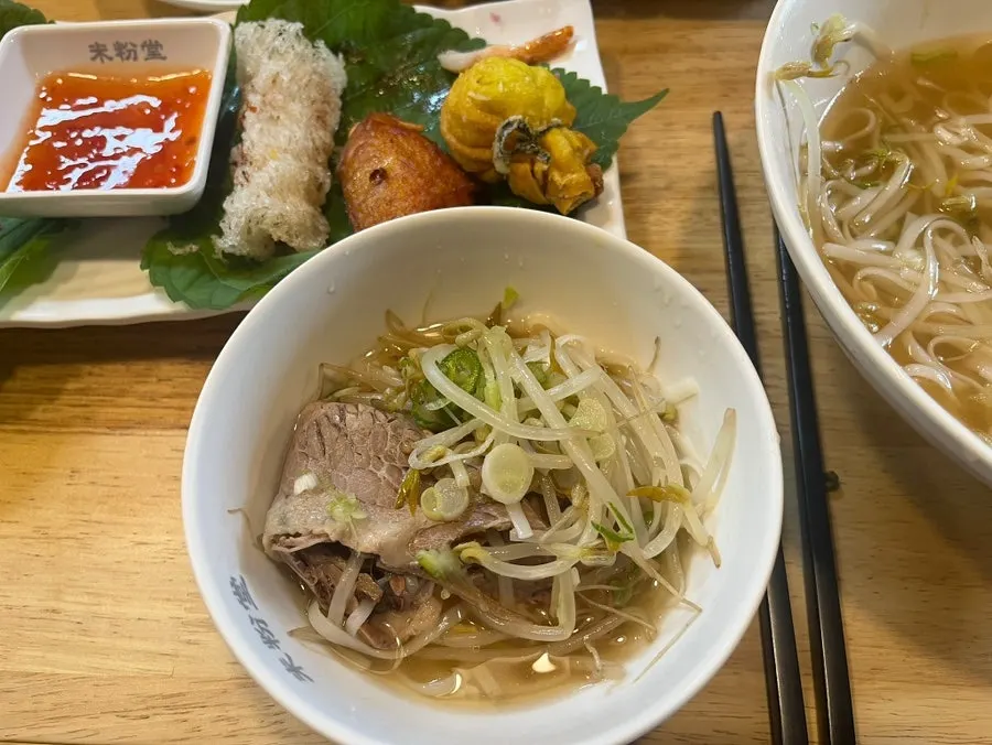 Soft pho noodles lifted with chopsticks