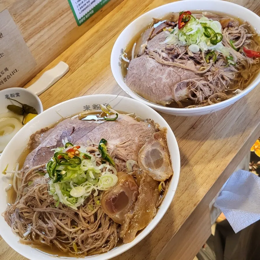 Close-up of pho and meat in a large bowl