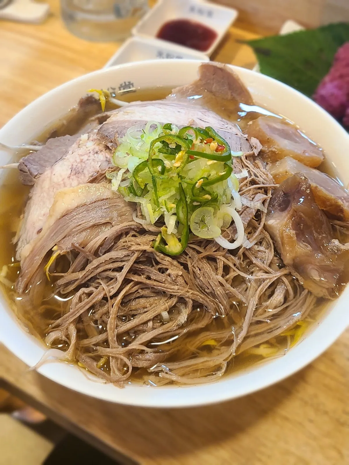 Pho topped with three kinds of meat: brisket, sirloin, and tendon