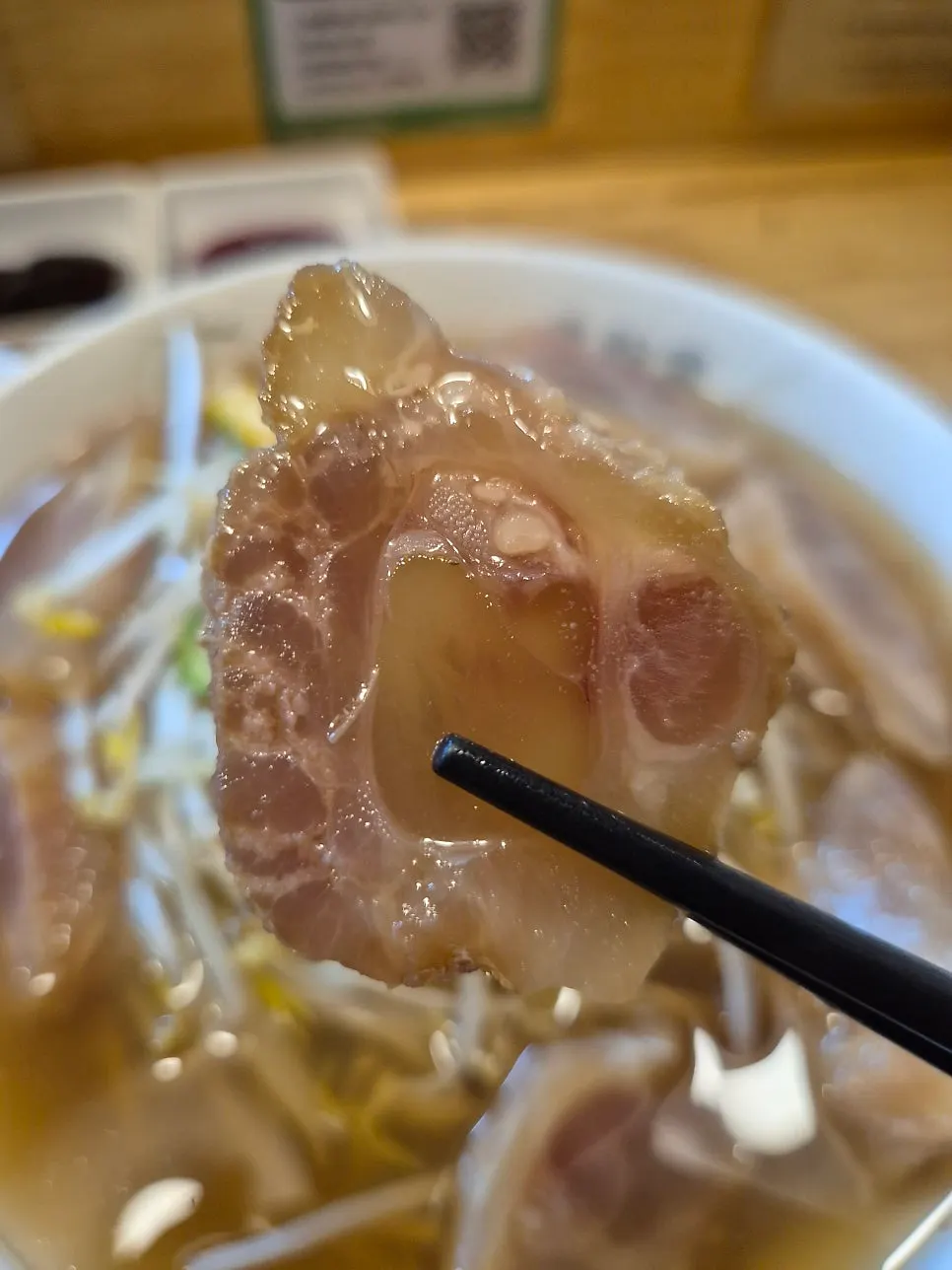 Close-up of the toppings on brisket-tendon pho