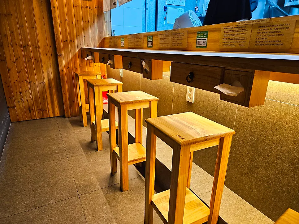Hooks behind the table for hanging coats and bags