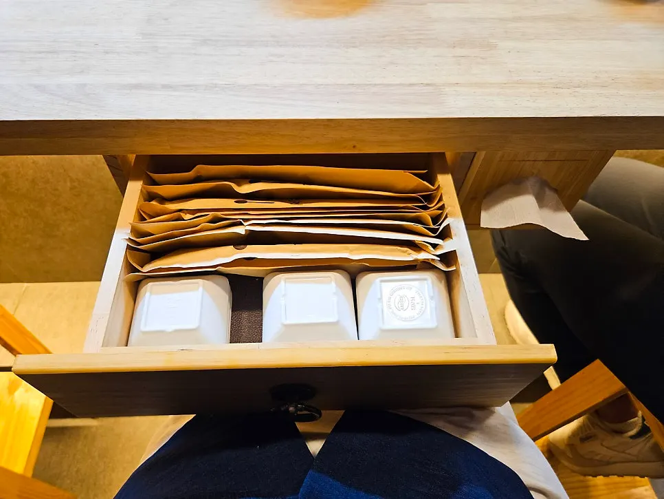 Drawer under the table storing utensils and napkins