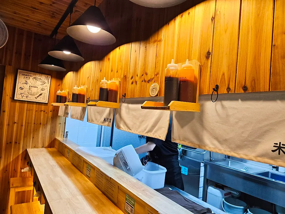 Seating setup with sauces kept on a shelf up on the wall