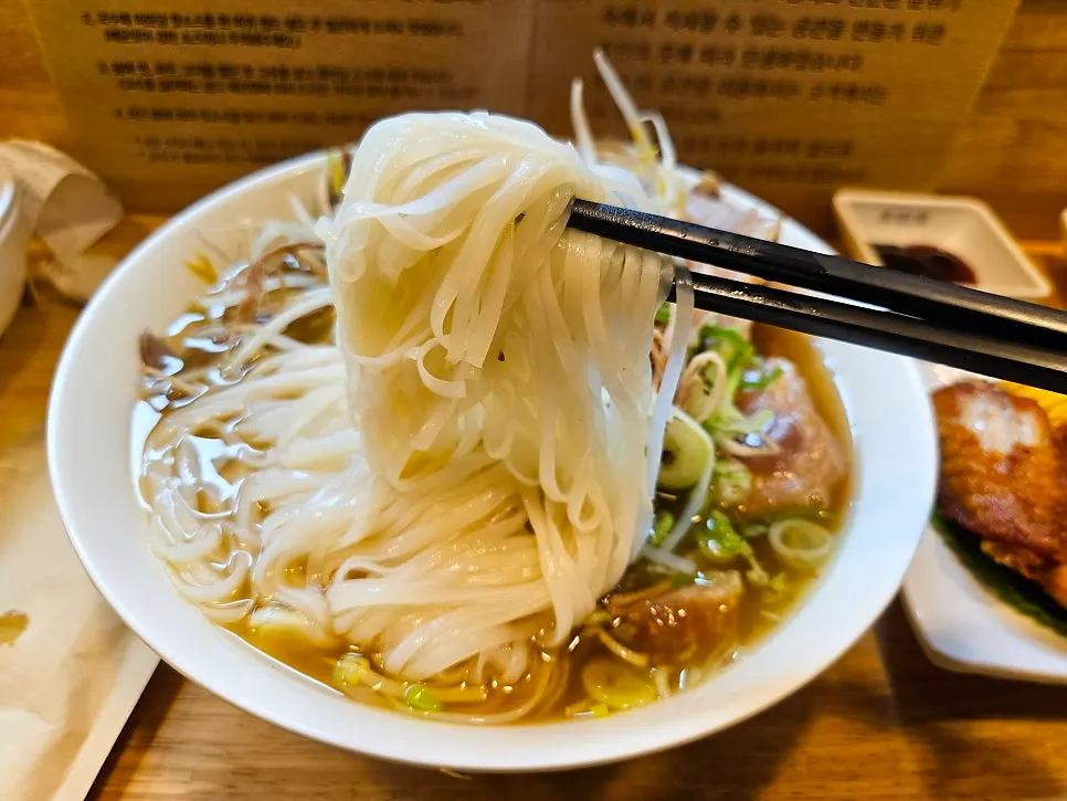 Table set with a bowl of pho