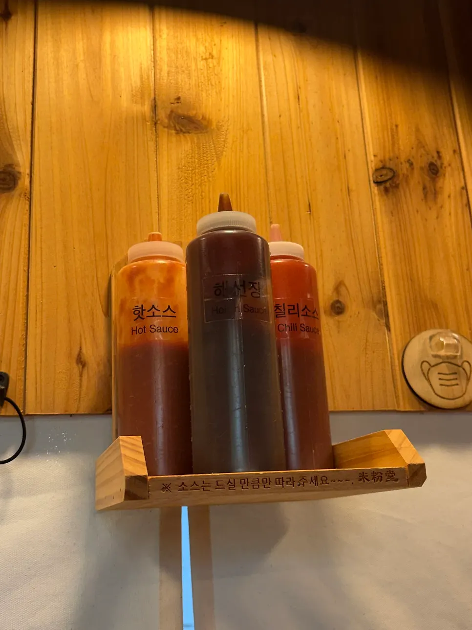 Sauce bottles placed above the seats