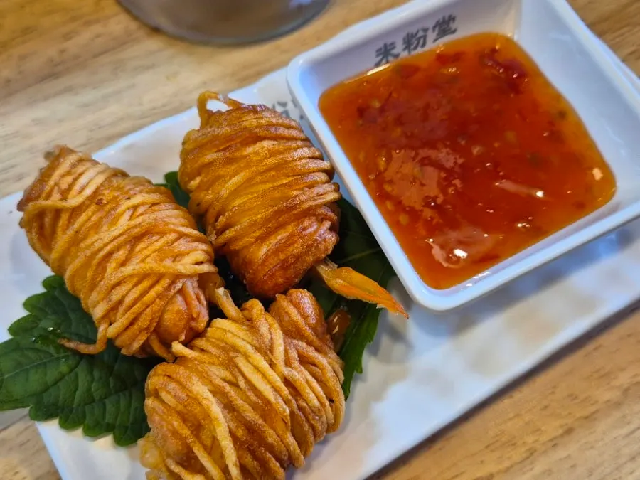Side dish of three shrimp potato rolls