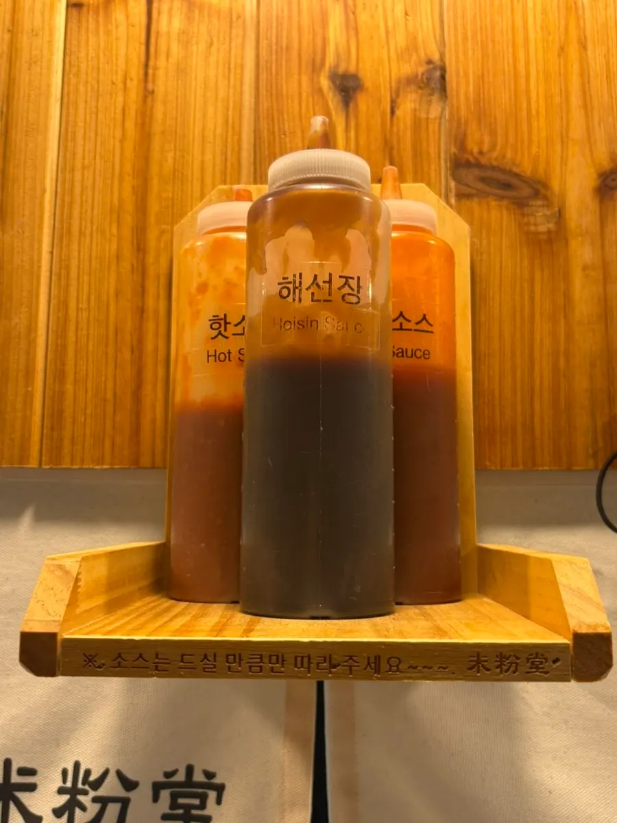 Hoisin sauce, hot sauce, and chili sauce on the shelf