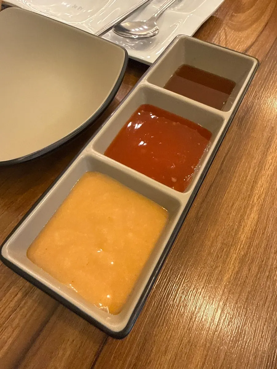 Three sauces: soy sauce, chili, and peanut