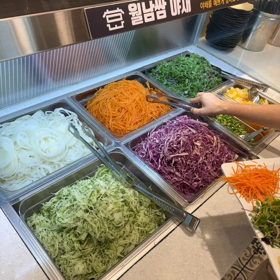 Self-serve bar stocked with vegetables and sides