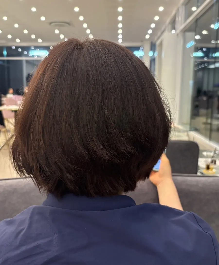 Side view of short hair tucked behind the ears