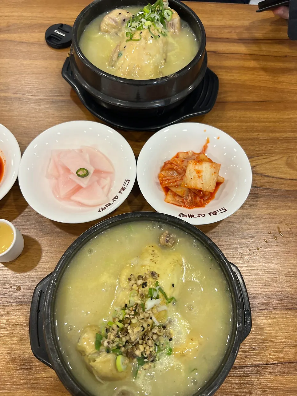 Table setting with two pots of Dream Samgyetang and mung bean samgyetang
