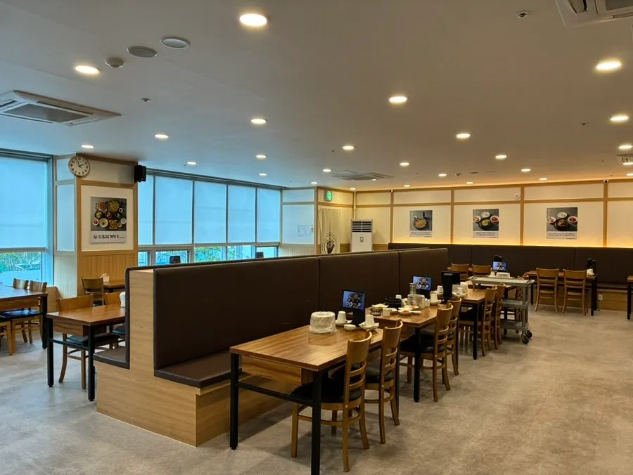 Interior lit with natural light through floor-to-ceiling windows