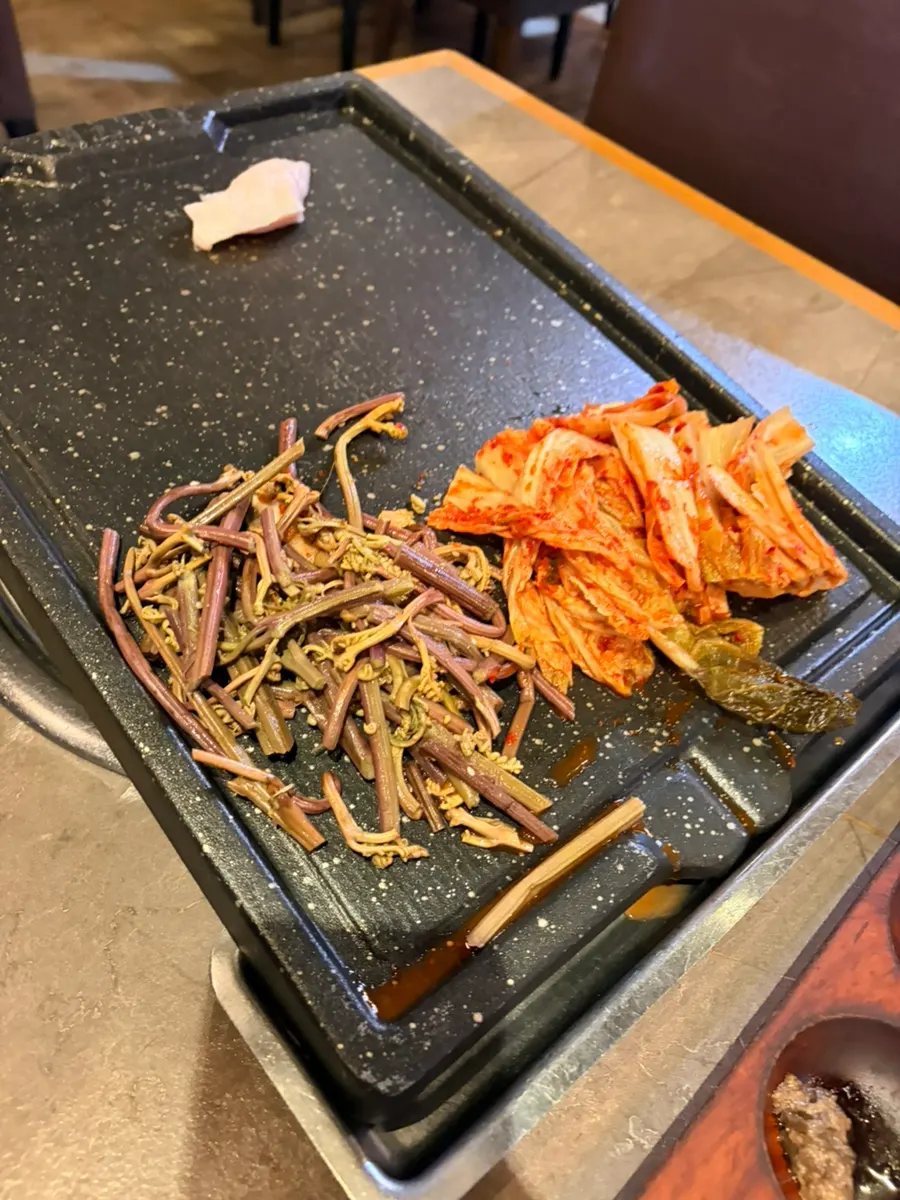 Generous banchan served with grilled meat