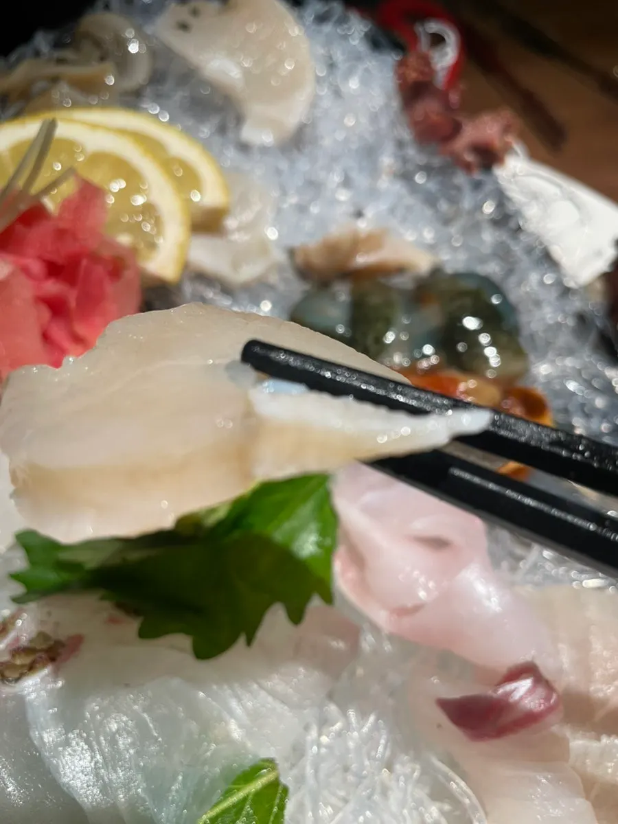A piece of sashimi from the mixed seafood platter
