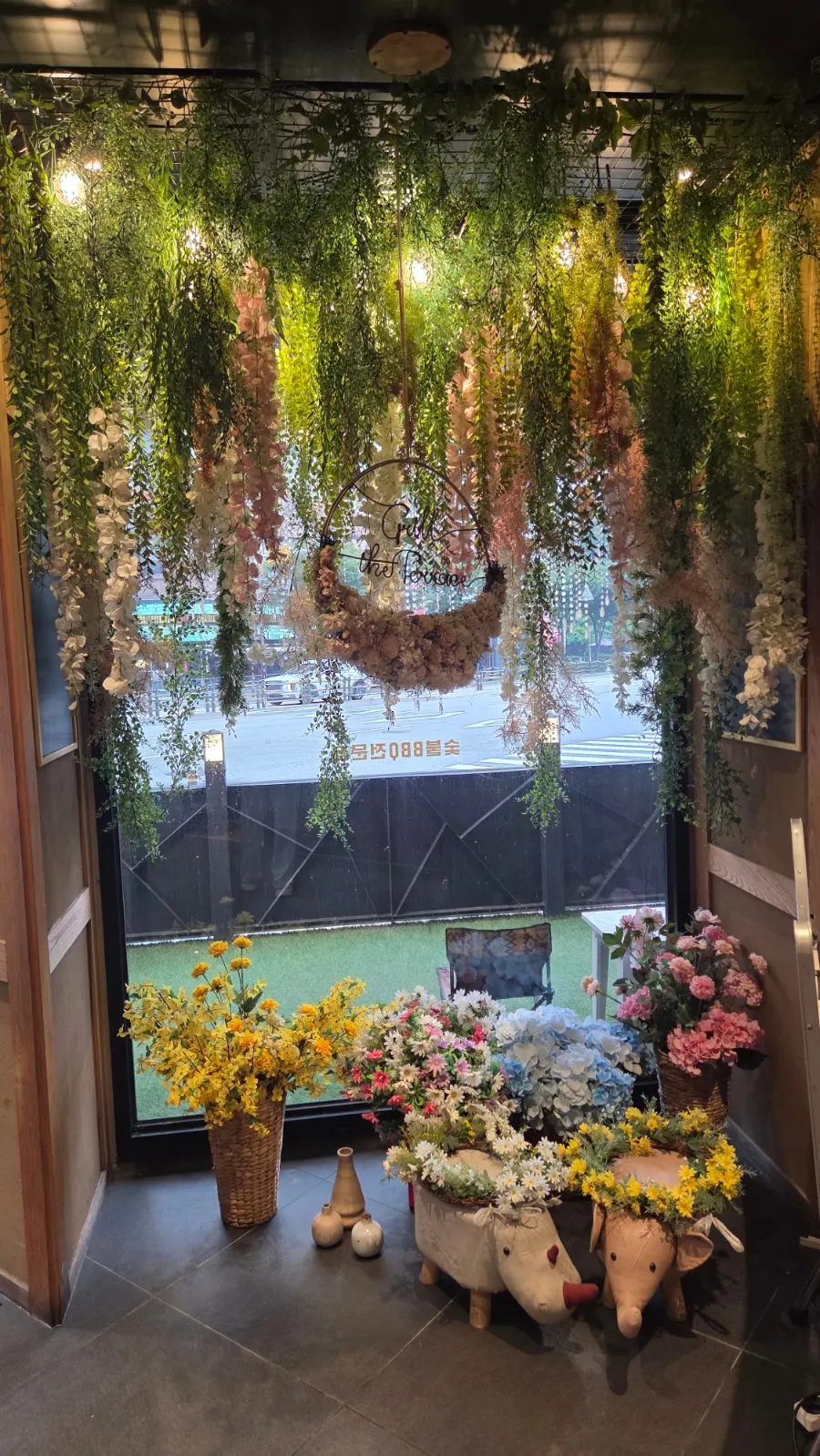 Green, greenery-filled BBQ restaurant interior