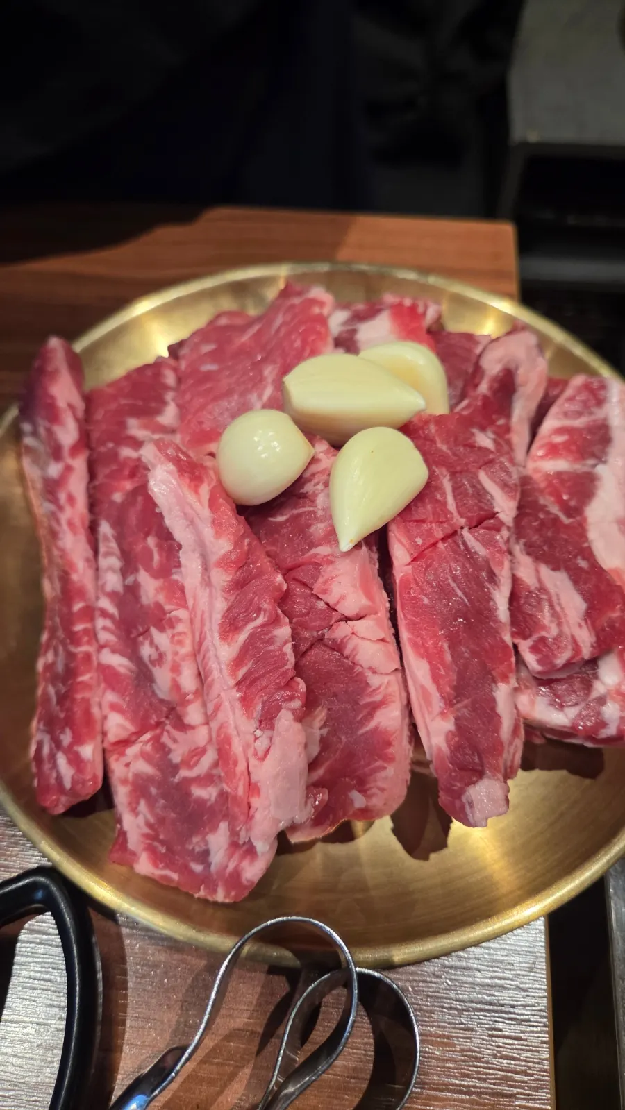Fresh beef short ribs grilling over charcoal