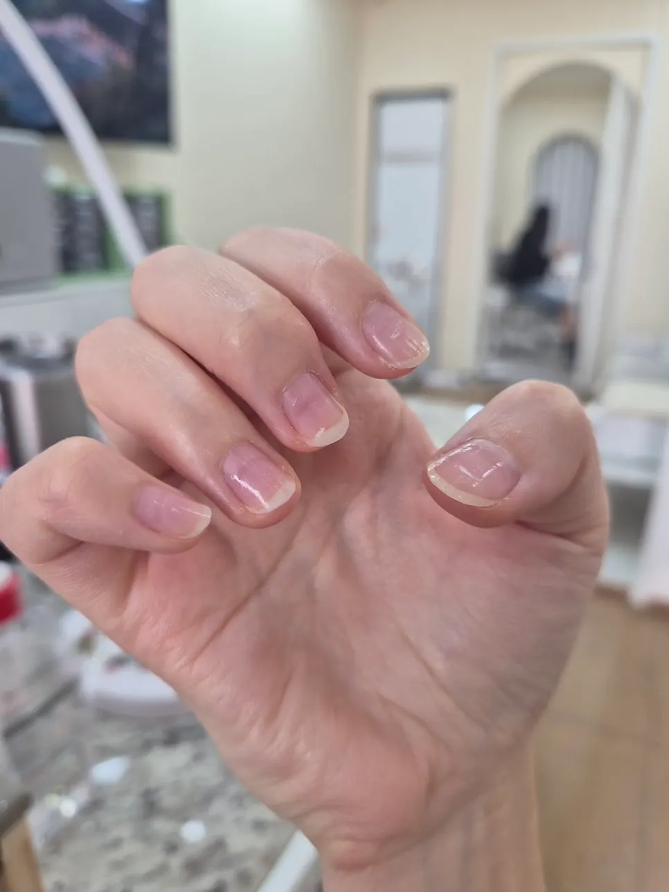 Consultation over pale pink powder nail design drafts