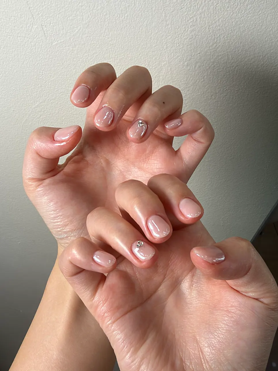 Glitter added over pale pink syrup gel nails
