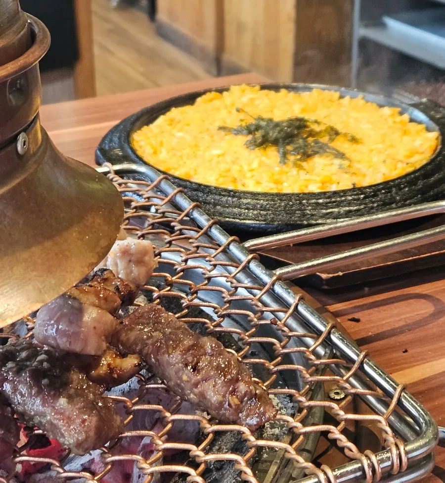 Table spread with kkakdugi fried rice alongside the meat