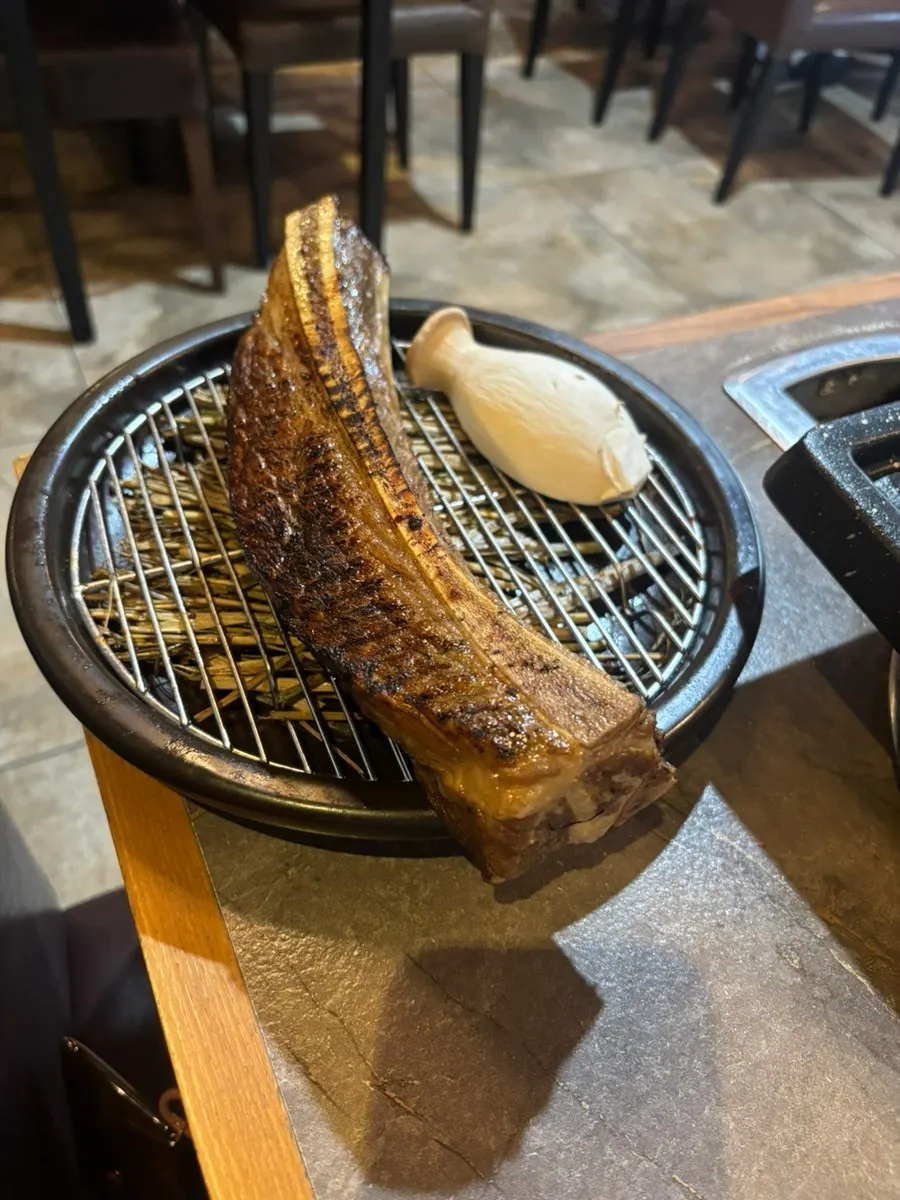 Udae galbi being par-seared over straw fire