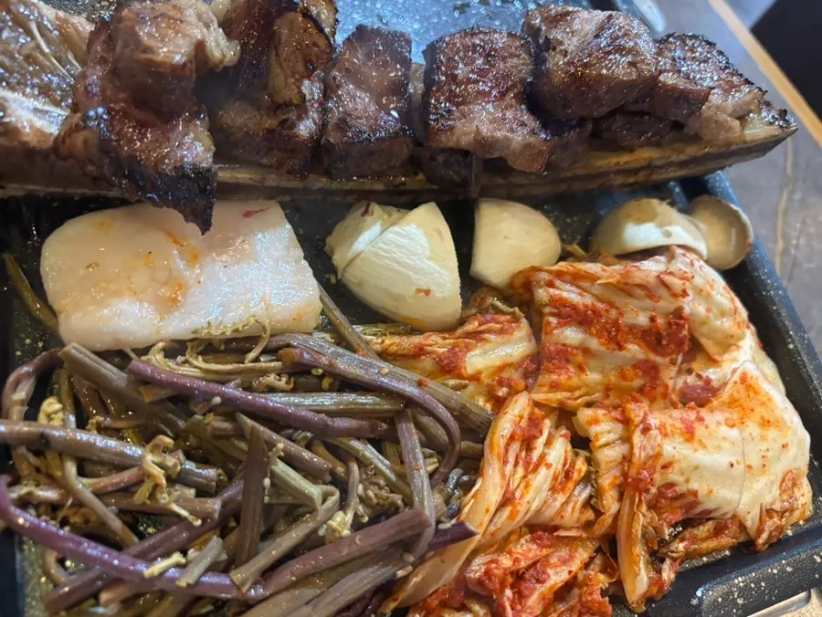 A staff member grilling udae galbi
