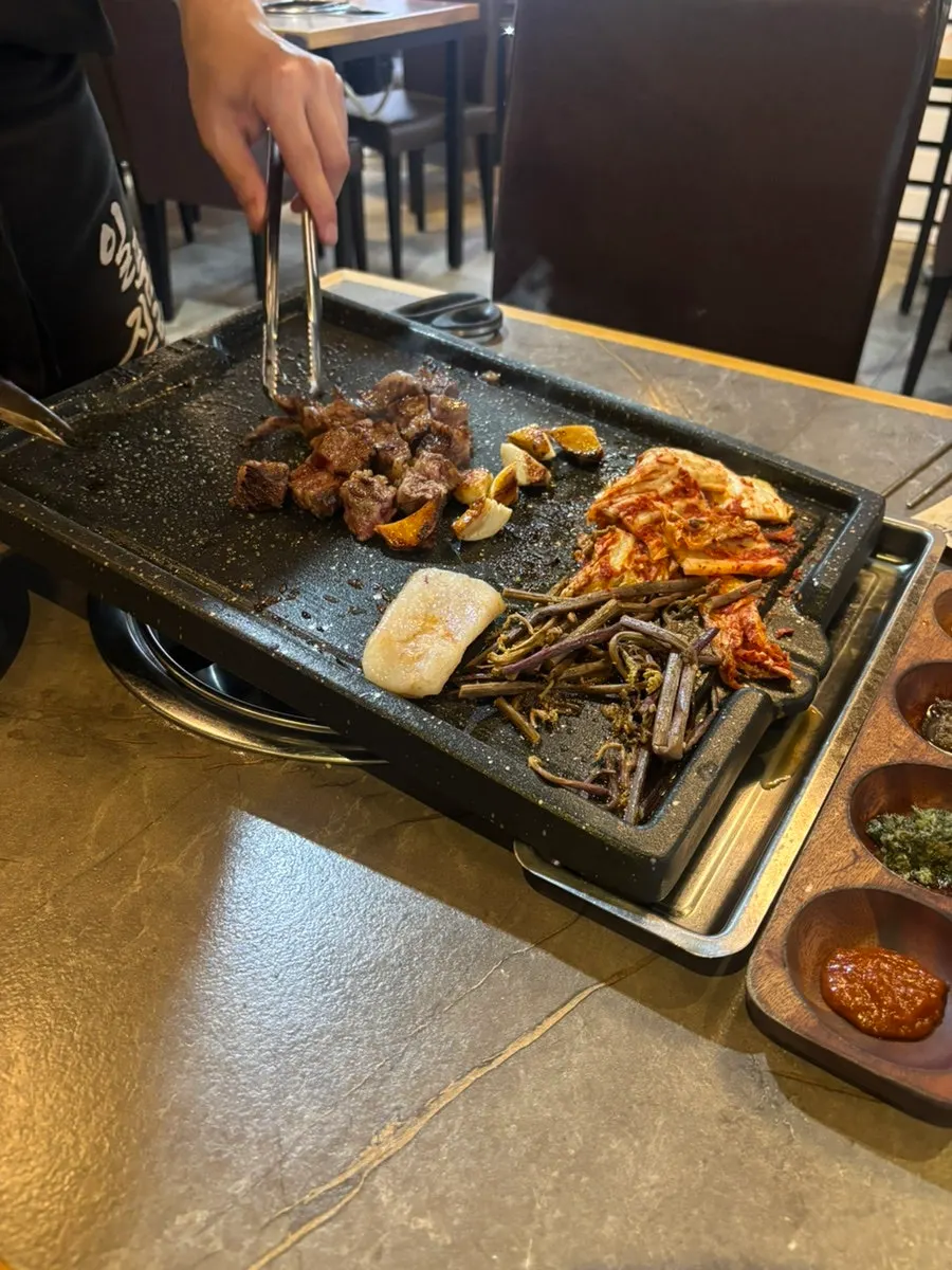 Udae galbi with the meat attached to the bone being trimmed