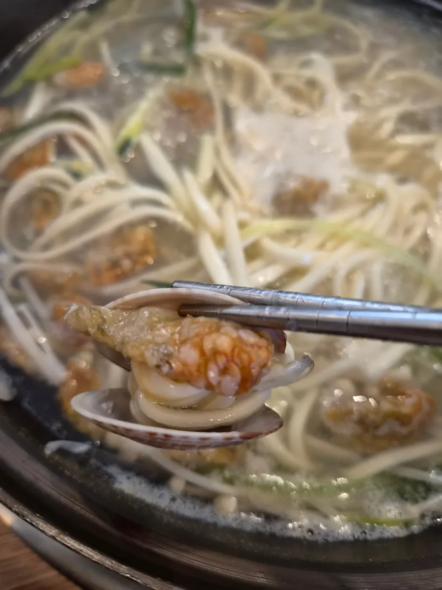 Kalguksu noodles and broth served in a bowl