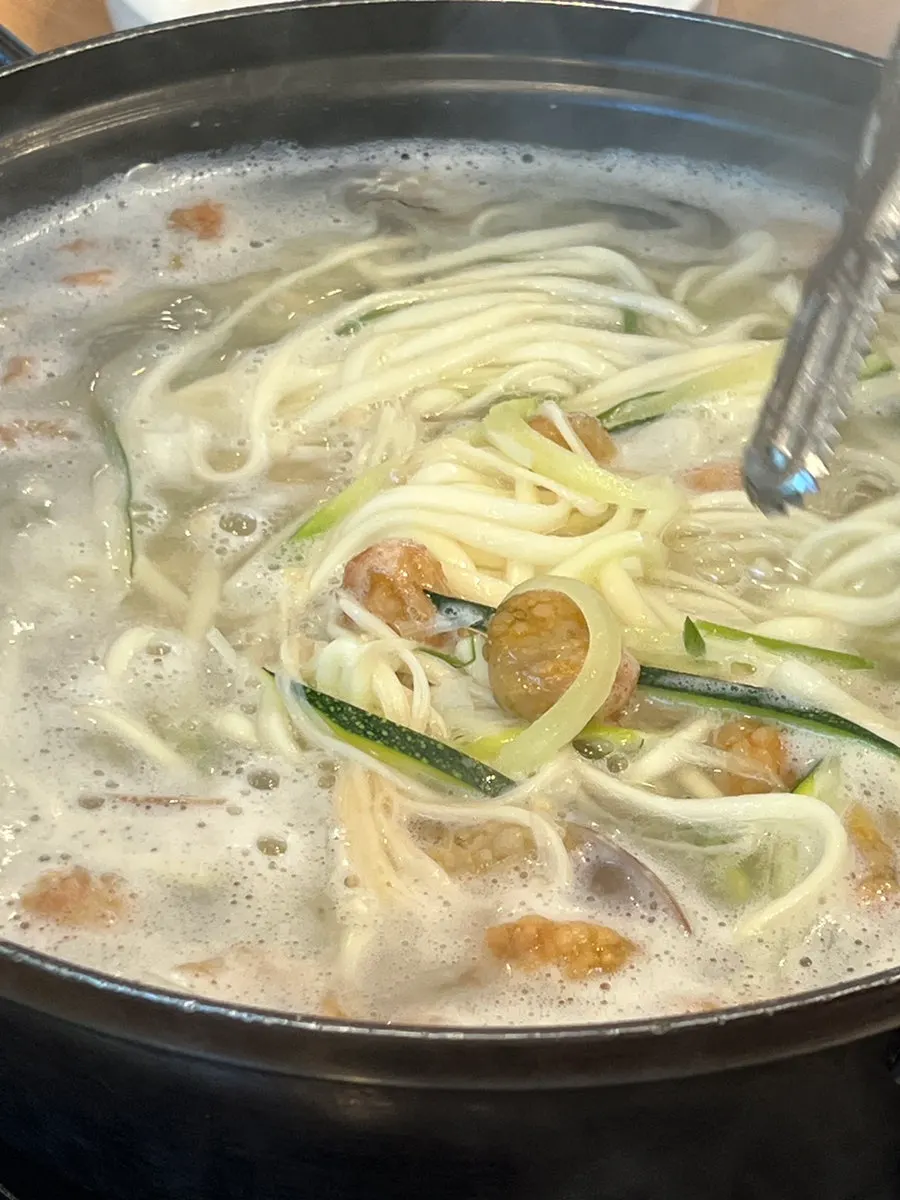 A bowl of bok-haemul kalguksu with hot broth