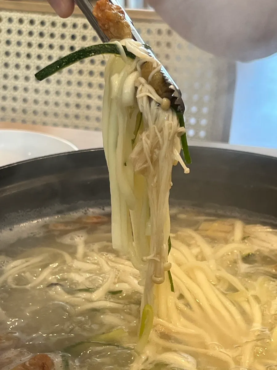 Chewy kalguksu noodles lifted from the broth