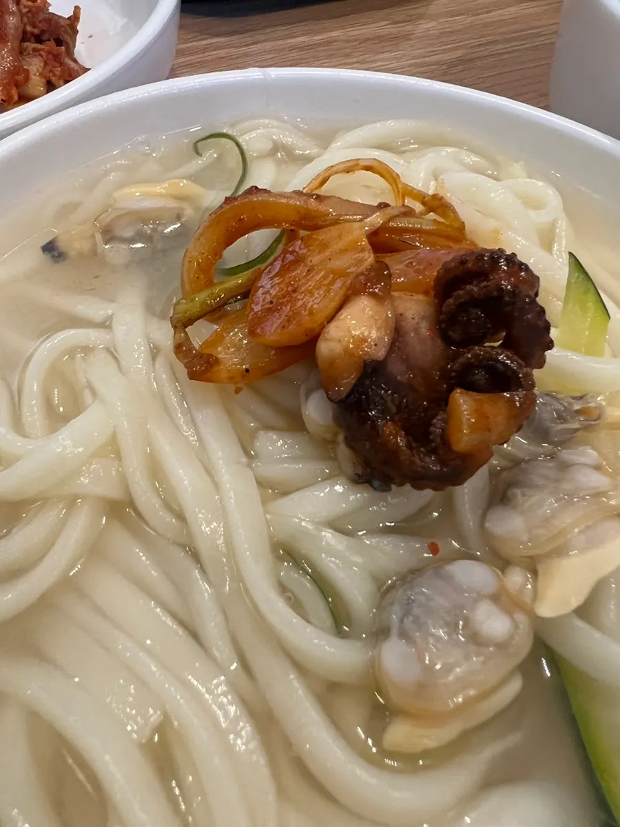 A hearty set table with kalguksu and octopus
