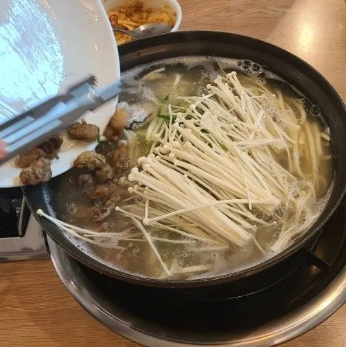 Seafood kalguksu simmering on the table