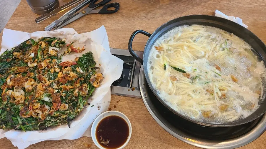 Kalguksu and buchujeon spread finished by two people