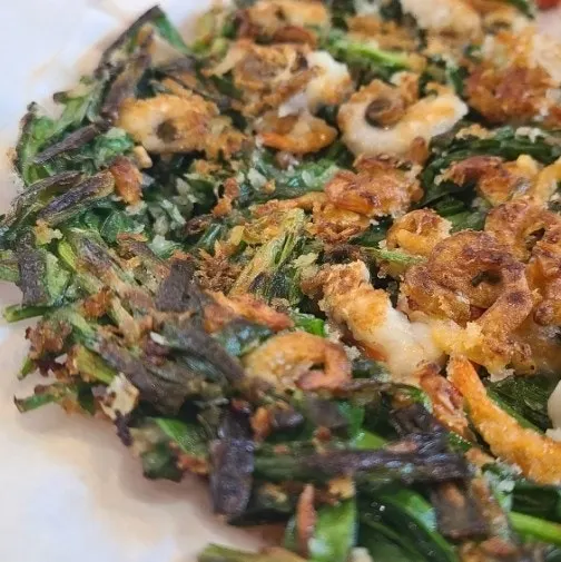A piece of haemul buchujeon fried crisp on the outside
