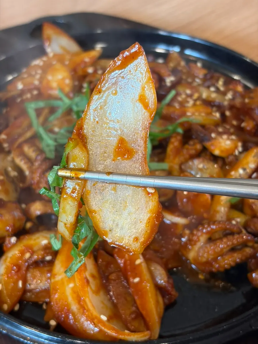 Picking up a large piece of octopus