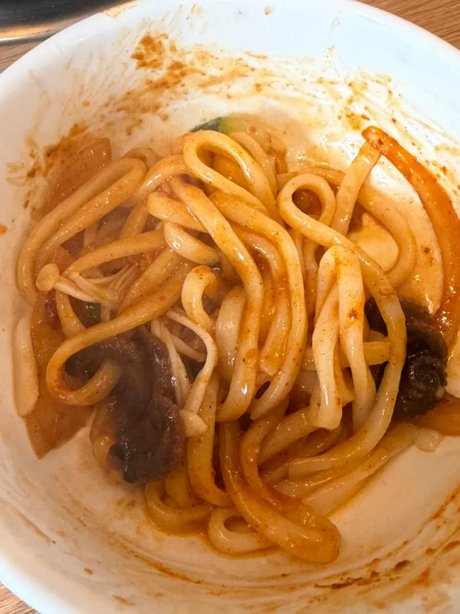 Moving kalguksu noodles into the octopus sauce