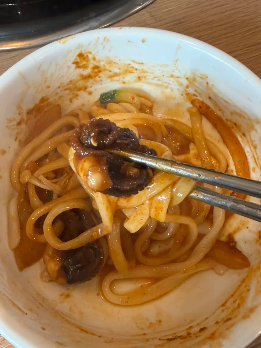 Kalguksu noodles mixed with octopus sauce